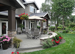 The built in seating faces the view and doubles as a retaining wall. The main terrace seat wall provides room for serving trays, while adding addition informal seating for party guests.
