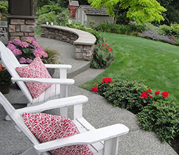 The built in seating faces the view and doubles as a retaining wall. Master bedroom lobe of covered garden view terrace.