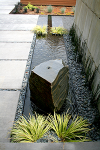 The stone was drilled and centered on the steel basin, one of the few symmetrical alignments on the job. The rill makes a right hand turn as it stretches towards the spillway on the other side of the steel wall. The stone was drilled and centered on the steel basin, one of the few symmetrical alignments on the job. The rill makes a right hand turn as it stretches towards the spillway on the other side of the steel wall.